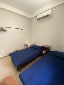 a hospital room with two beds and a fan at Hostel Concordia/Nova floresta in Belo Horizonte