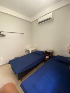 a hospital room with two beds and a air conditioner at Hostel Concordia/Nova floresta in Belo Horizonte