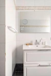 een witte badkamer met een wastafel en een douche bij Casa amoR in Trastevere in Rome