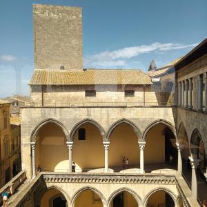 a view of a building with arches and a tower at Appartamento vista mare Tarquinia in Tarquinia