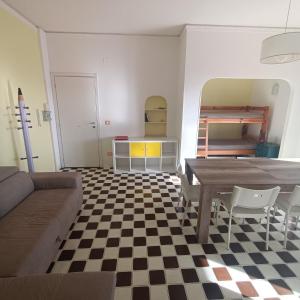 a living room with a table and a checkered floor at Appartamento vista mare Tarquinia in Tarquinia