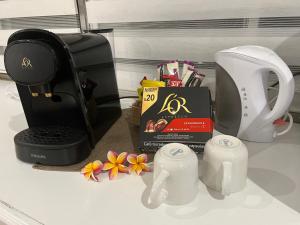 a counter top with a coffee maker and a blender at Heitiare lodge in Paea