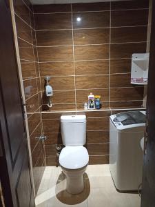 a bathroom with a toilet with wooden walls at منتجع فلورانزا 50 in Hurghada