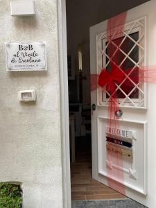 a door with a sign that reads best at music in excellence at Al Vicolo di Ercolano in Ercolano