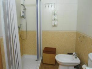 a bathroom with a shower and a toilet and a sink at Etna Sun Guest House in Mascali