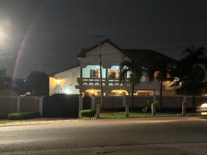 a house at night with a street in front of it at D Barfi Guesthouse, excellent location in Kumasi
