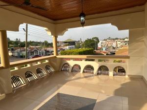 a balcony with a view of a city at D Barfi Guesthouse, excellent location in Kumasi