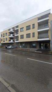a large building with a parking lot in front of it at Apartman Solunska 18 Banja Luka in Banja Luka