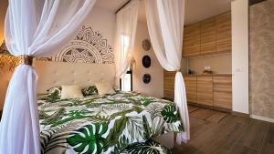 a bedroom with a bed with a green and white bedspread at The Green Hut - Costa Adeje in Adeje