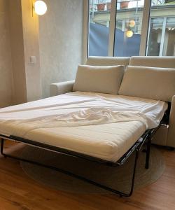 a bed sitting in a room with a couch at Atrium Apartments Aachen in Aachen