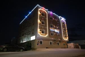 a building with lights on top of it at night at Ru'a Al Qunfudhah Furnished Units in Al Qunfudhah