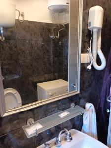 a bathroom with a sink and a mirror at levante rooms in Scalea