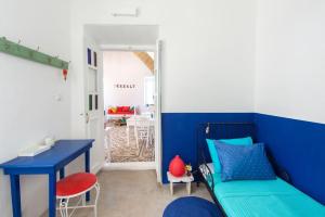 a blue room with a bed and a blue desk at seasalthouse - famous tv location in Koskinou +13 photos