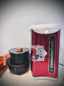 a red and white toaster sitting on a counter at Junest Hut in Pantai Cenang