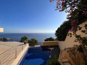 a swimming pool with a view of the ocean at Villa Sa Calma in Begur