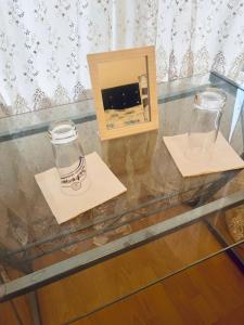 a glass table with a vase and a box on it at Mia Property - Two Mile Hill in Bristol