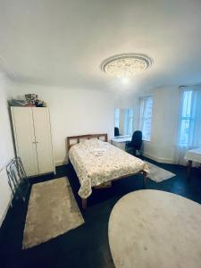 a room with a bed and a cabinet and two rugs at Mia Property - Two Mile Hill in Bristol
