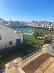 a view of a park from a balcony of a building at Costa esuri CASA TRINIDAD in Huelva