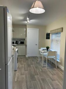 a kitchen and dining room with a table and a table and chairs at Modern Relaxing Apartment in Stoke on Trent
