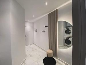 a white room with a washer and dryer at Suncity Tirana Luxury Apartments (Ap. 01) in Tirana