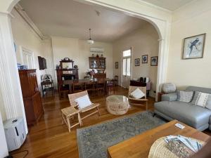 a living room with a couch and a table at Riversleigh House in Ballina