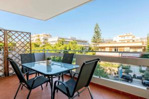 a table and chairs on a balcony with a view at Boutique52 Luxury Apartments in Athens