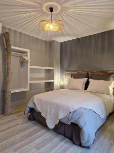 a bedroom with a large bed with a ceiling at Gîte Carcasso in Carcassonne