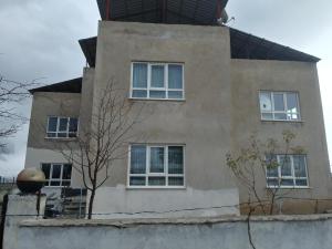 a building with windows and a tree in front of it at enesin evi in Kayseri