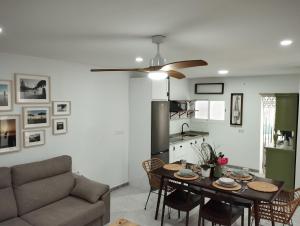 a living room with a table and a couch at LA PONDEROSA BEACH in Sanlúcar de Barrameda