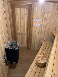 a wooden room with a stove in the middle of it at Luxury suite with Sauna and Spa Bath - Elkside Hideout B&B in Canmore