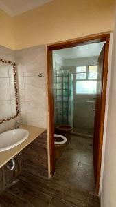 a bathroom with a tub and a toilet and a sink at Ruca Epu in Las Grutas