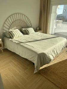 a bedroom with a large bed with a large headboard at Marina & Beach front Bliss in Benalmadena Costa