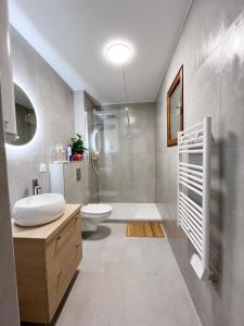 a bathroom with a sink and a toilet and a shower at Magic Spa Studio Jacuzzi near Disneyland in Crecy la Chapelle