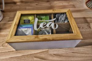a wooden box with the word tea in it at Magic Spa Studio Jacuzzi near Disneyland in Crecy la Chapelle