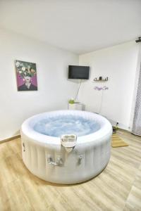 a large white bath tub in a room at Magic Spa Studio Jacuzzi near Disneyland in Crecy la Chapelle