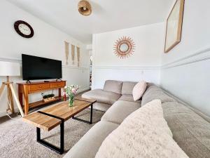 a living room with a couch and a tv at Alwaves Family 3 Bedroom Beach Apartment in Wildwood