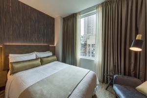 a hotel room with a bed and a window at Marriott Vacation Club Pulse, New York City in New York