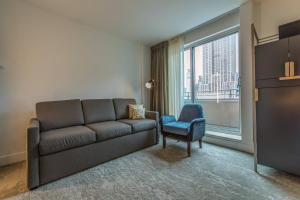 - un salon avec un canapé, une chaise et une fenêtre dans l'établissement Marriott Vacation Club®, New York City , à New York