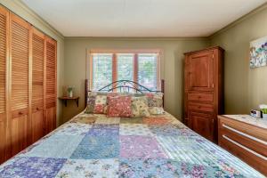 a bedroom with a bed with a quilt on it at Lakeview Retreat in Lakeville