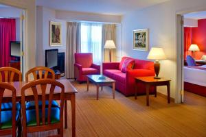 a living room with a couch and a bed at Residence Inn Boston Andover in Andover