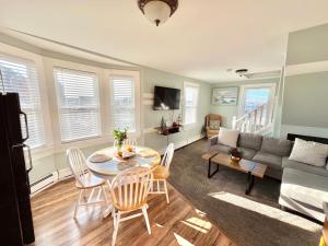 a living room with a table and chairs and a couch at Entire Lovely 3 Bedroom, 2 Bathroom Apartment! 1 Block to the Beach and Boardwalk! in Wildwood