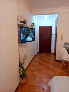 a living room with a television on a wall at Rent Ibera Nuñez in Buenos Aires