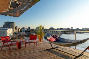 a hammock on a deck with a view of the water at Moxy Bordeaux in Bordeaux