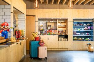 a room with a kitchen with luggage in it at Moxy Bordeaux in Bordeaux