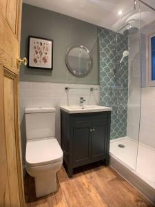 a bathroom with a toilet and a sink and a shower at Cosy 1 Bed Cottage Scarborough in Scarborough