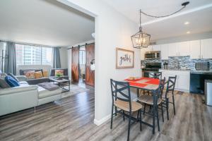 a kitchen and living room with a table and chairs at Welcoming Barn, 2 BEDROOM & 1 Bath & Parking in Atlanta