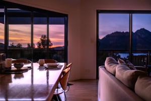 a living room with a table and a couch at The Bolthole in Coles Bay