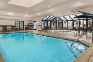 a large swimming pool with blue water in a building at Courtyard by Marriott Chicago Waukegan / Gurnee in Waukegan