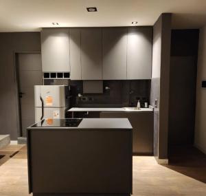 a kitchen with white cabinets and a white refrigerator at AMSTERDAM DEPARTAMENTOS in Villa Carlos Paz