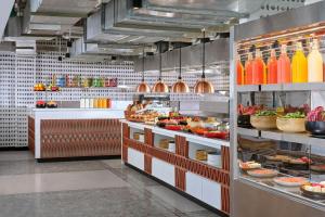 a kitchen with a lot of food on display at Aloft Bali Seminyak in Seminyak